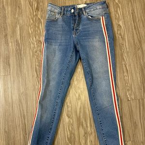 Jeans from Zara. Never worn. Medium wash with red and white stripe on the sides.